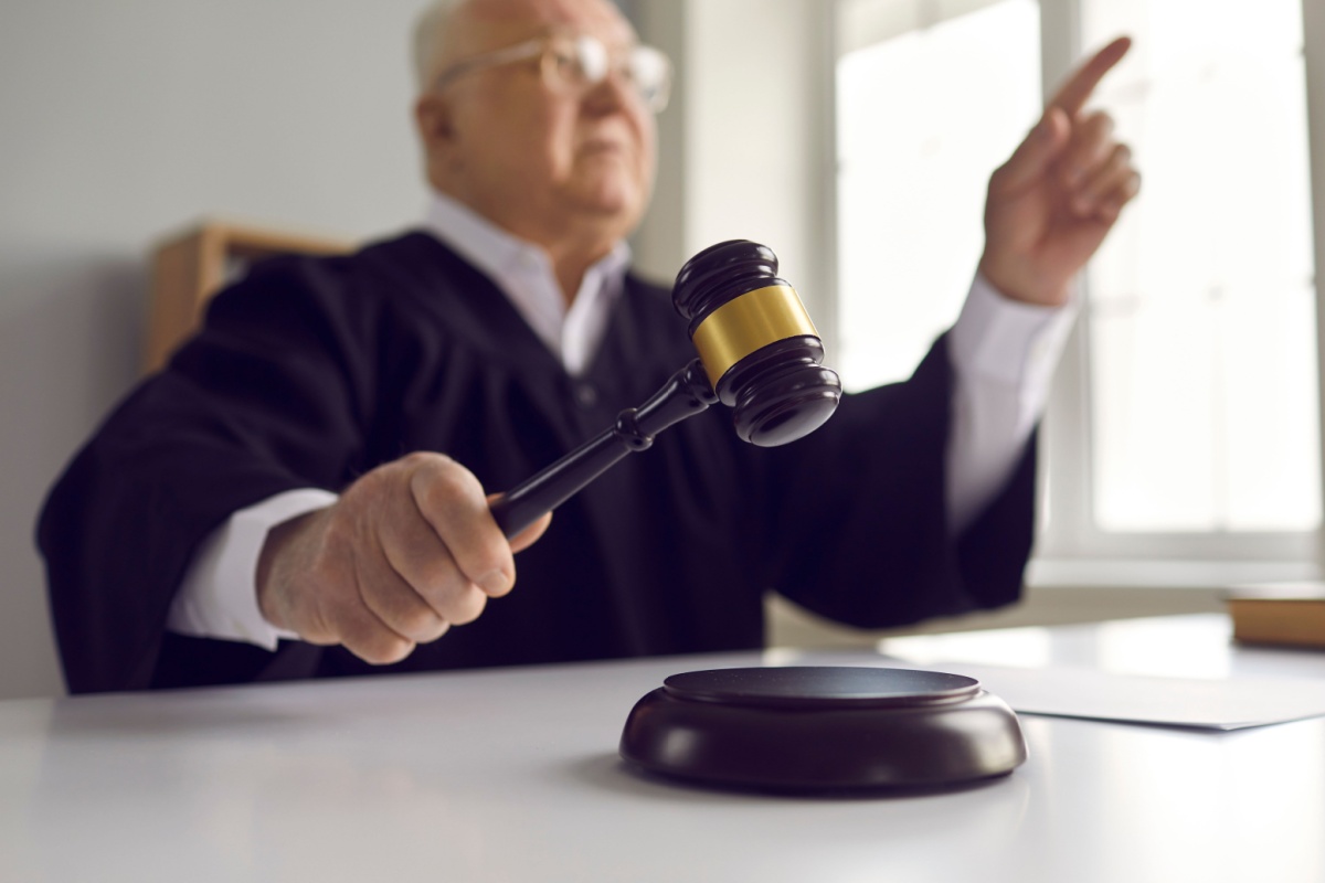Richter in Robe schlägt Hammer auf den Richtertisch – Urteil zum Wohngeld für Alleinerziehende